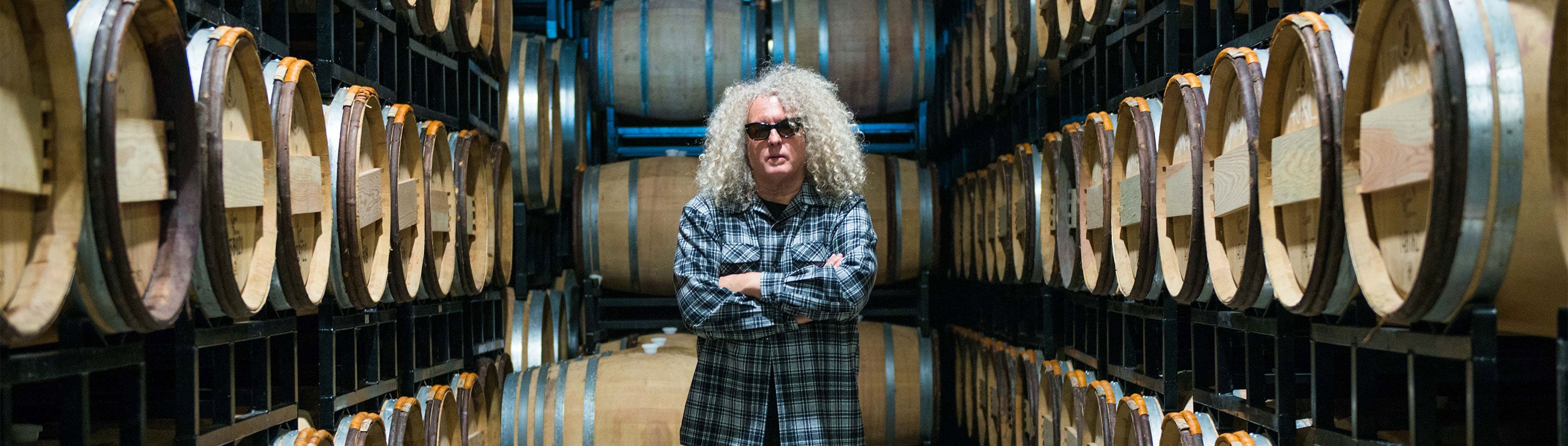 Charles Smith winemaker and his wine barrels